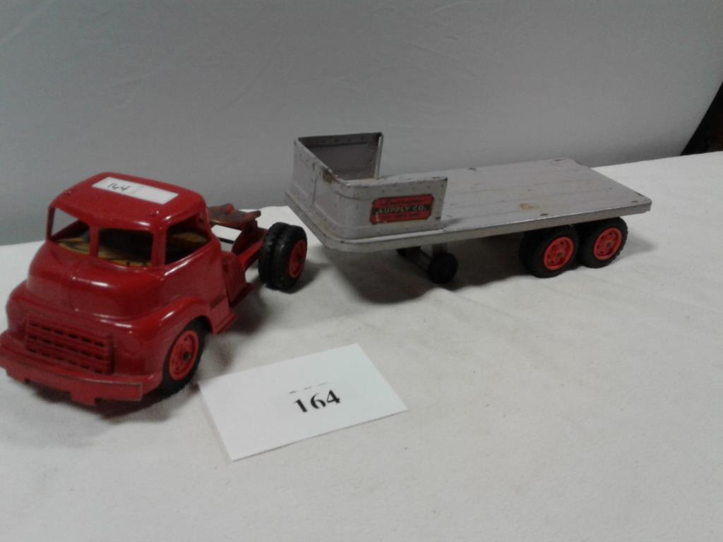 TOY WYANDOTTE PLASTIC SEMI TRACTOR WITH CONSTRUCTION SUPPLY CO TRAILER BED