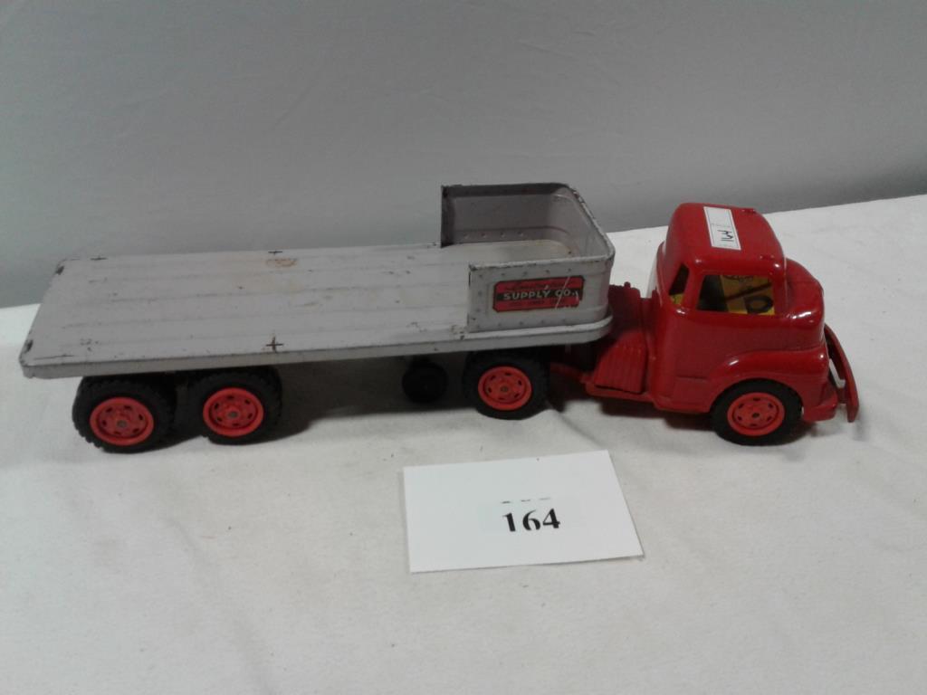 TOY WYANDOTTE PLASTIC SEMI TRACTOR WITH CONSTRUCTION SUPPLY CO TRAILER BED