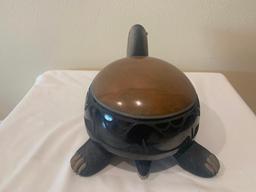 Black and sienna ceramic turtle with ?avanyu? motif and one turquoise eye