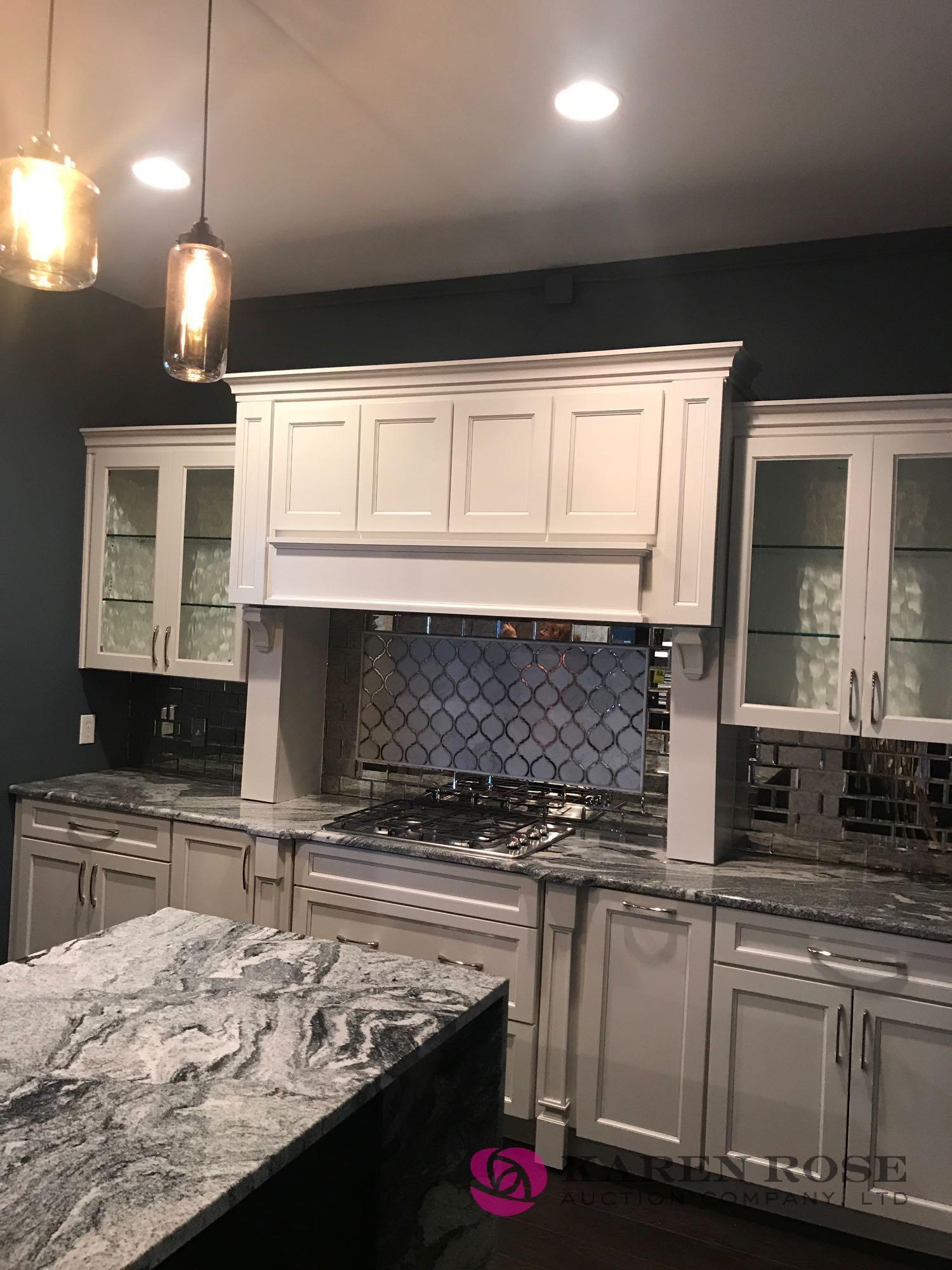 White Luxury kitchen and cabinets display with granite top