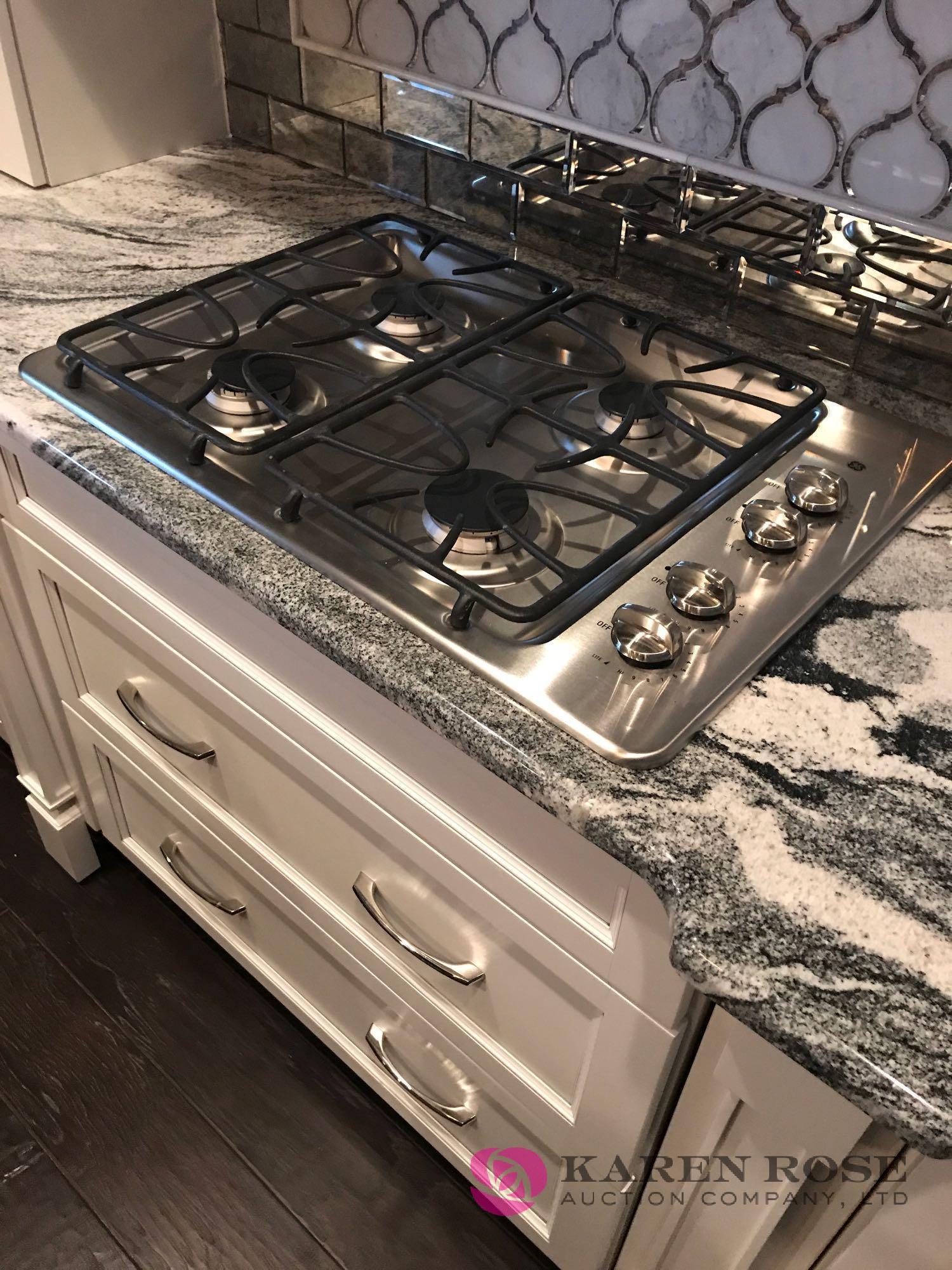 White Luxury kitchen and cabinets display with granite top