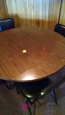 51 inch round Table with folding leaves and four chairs