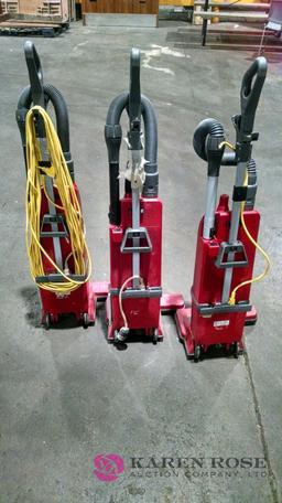 Three sanitaire commercial dual motor vacuums