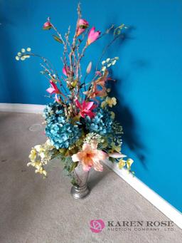 Artificial flower arrangement in metal vase