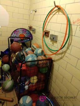 Room with a lot of basketballs, hoops, and sporting goods for kids