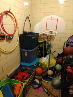 Room with a lot of basketballs, hoops, and sporting goods for kids