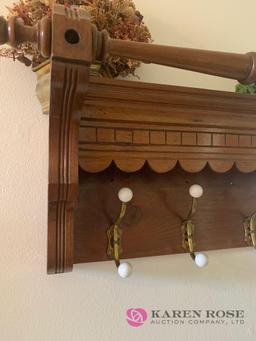 Wooden coat rack and artificial flowers