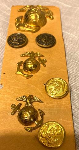 Lot of seven military pins and buttons