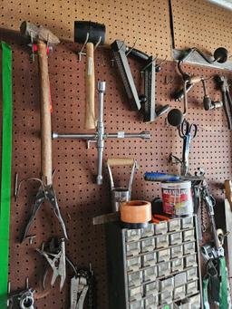 Assorted tools and miscellaneous on wall.