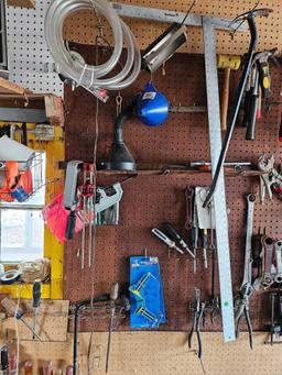 Assorted tools and miscellaneous on wall