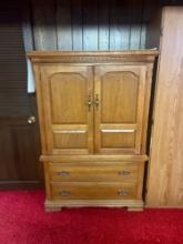 Tall dresser with doors in basement