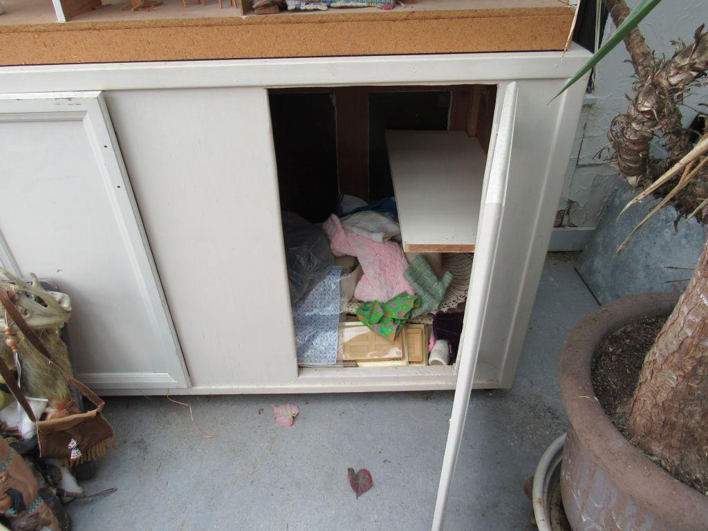 Wooden cabinet with doll house and accessories