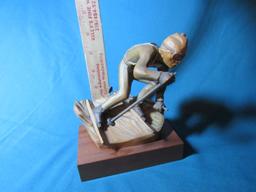 Hand carved downhill skier
