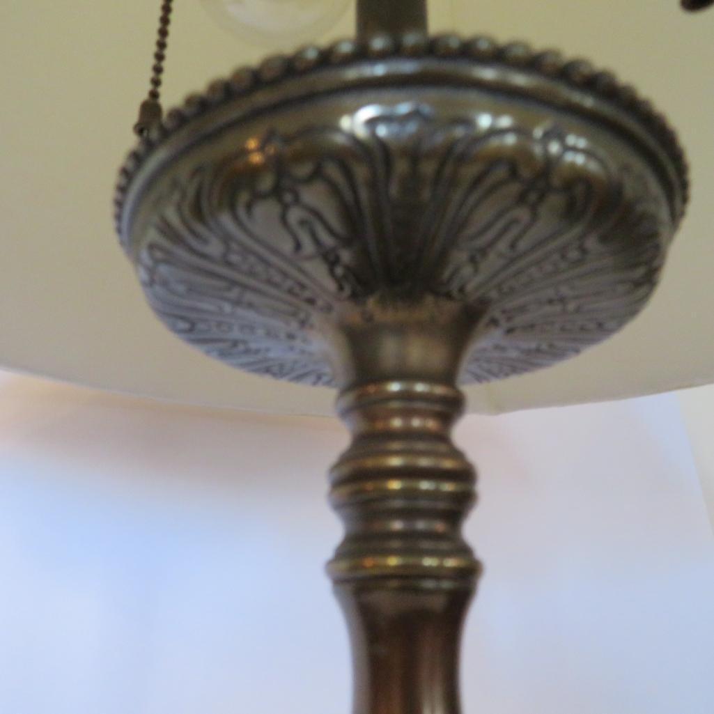 Ornate metal table lamp with faces and clawfeet