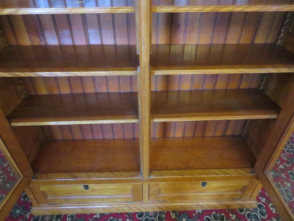 Beautiful maple two door bookcase with two drop down doors and carving