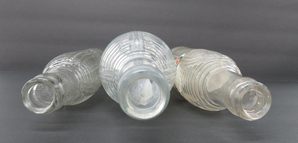 Three clear ribbed Orange Crush Bottles