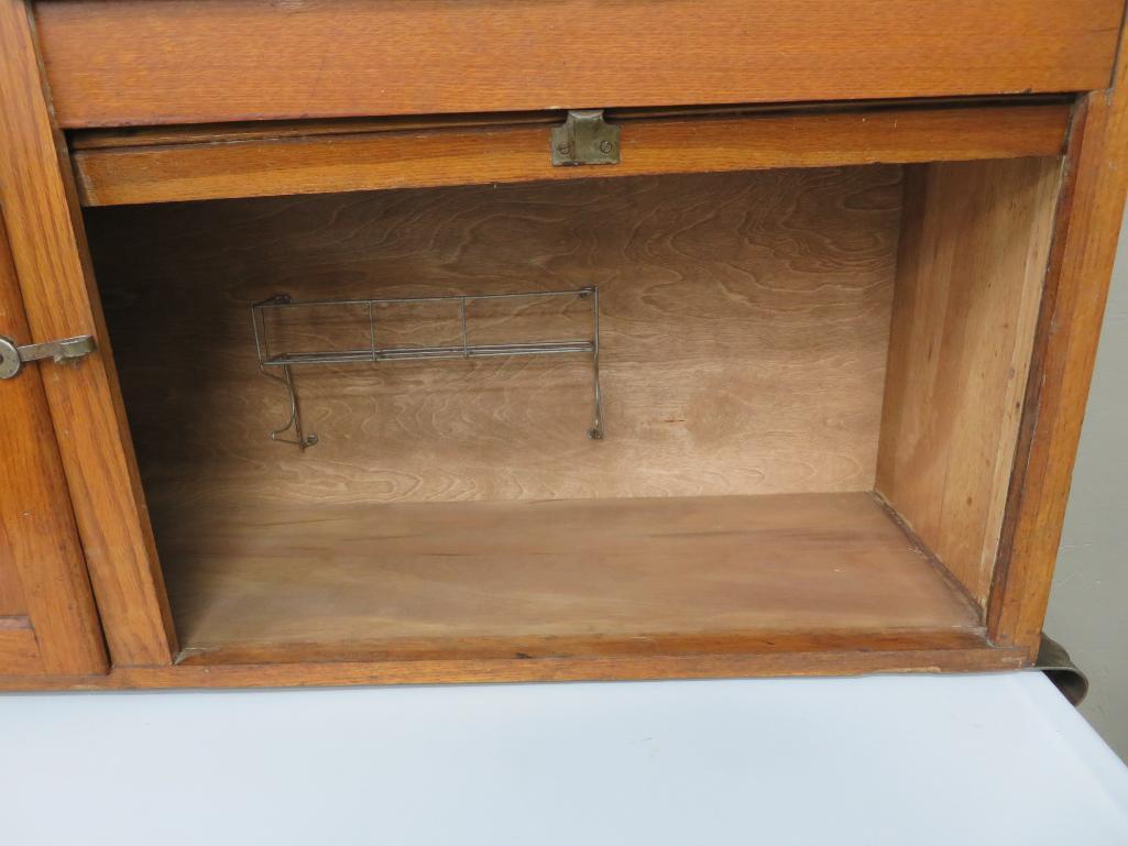 Oak Hoosier cabinet with flour bin and enamel top