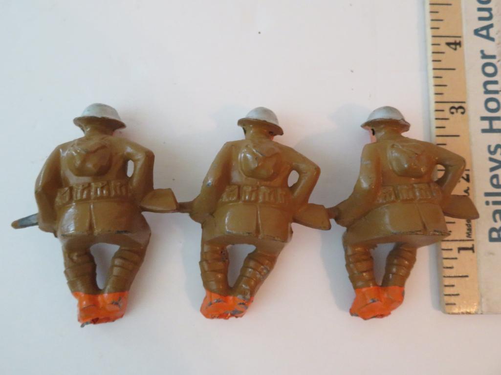 Cast iron carbide cannon and three seated soldiers