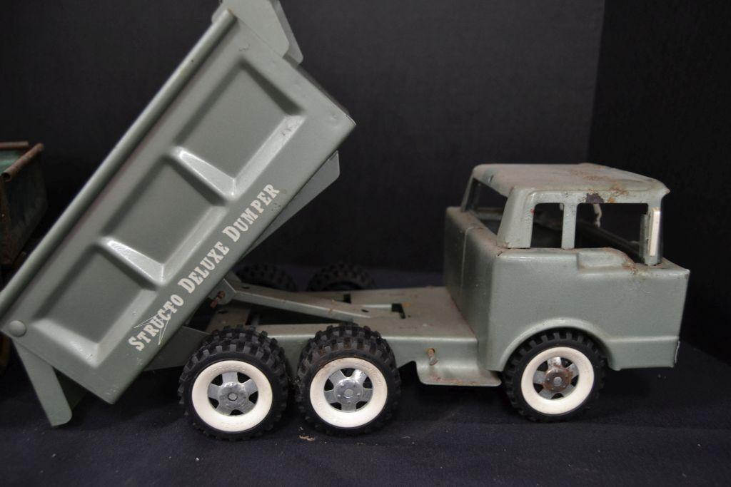 Pair of Structo Dump Trucks, 1 Deluxe, 1 rough, metal and plastic accessori