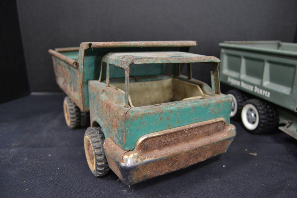 Pair of Structo Dump Trucks, 1 Deluxe, 1 rough, metal and plastic accessori