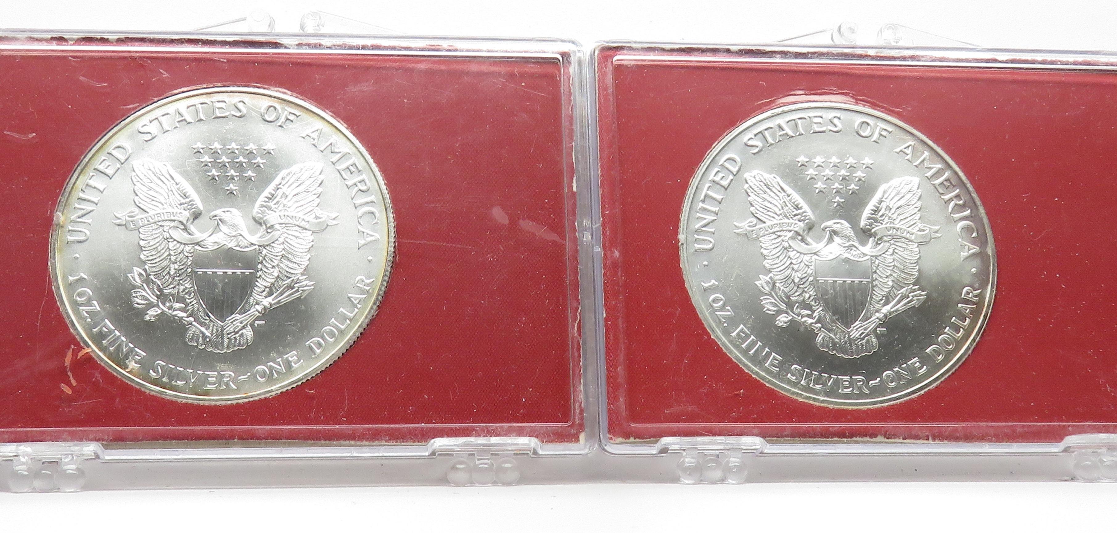 2 American Silver Eagles in plastic cases: 2000, 2002