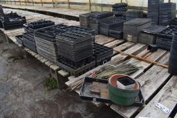 Assortment of bamboo sticks and plastic plant trays, located in GH 24