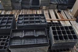 Assortment of bamboo sticks and plastic plant trays, located in GH 24