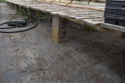 Approx. 180' of wooden greenhouse garden benches 60" and 84" wide with cinder blocks,