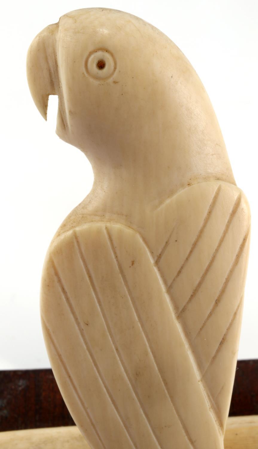 ANTIQUE IVORY PARROT ON A PERCH FIGURINW