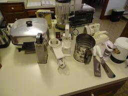 All items on counter: Electric frying pan, blender, electric can opener, grater, toaster oven, plus