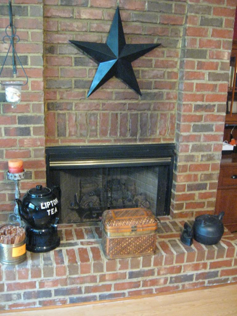 Hearth items: Star, ice tea dispenser, basket, candle, gold bucket w/kindling, tea pot and iron