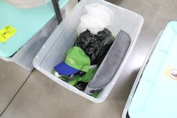 Plastic tub full of hats and napkin holder.