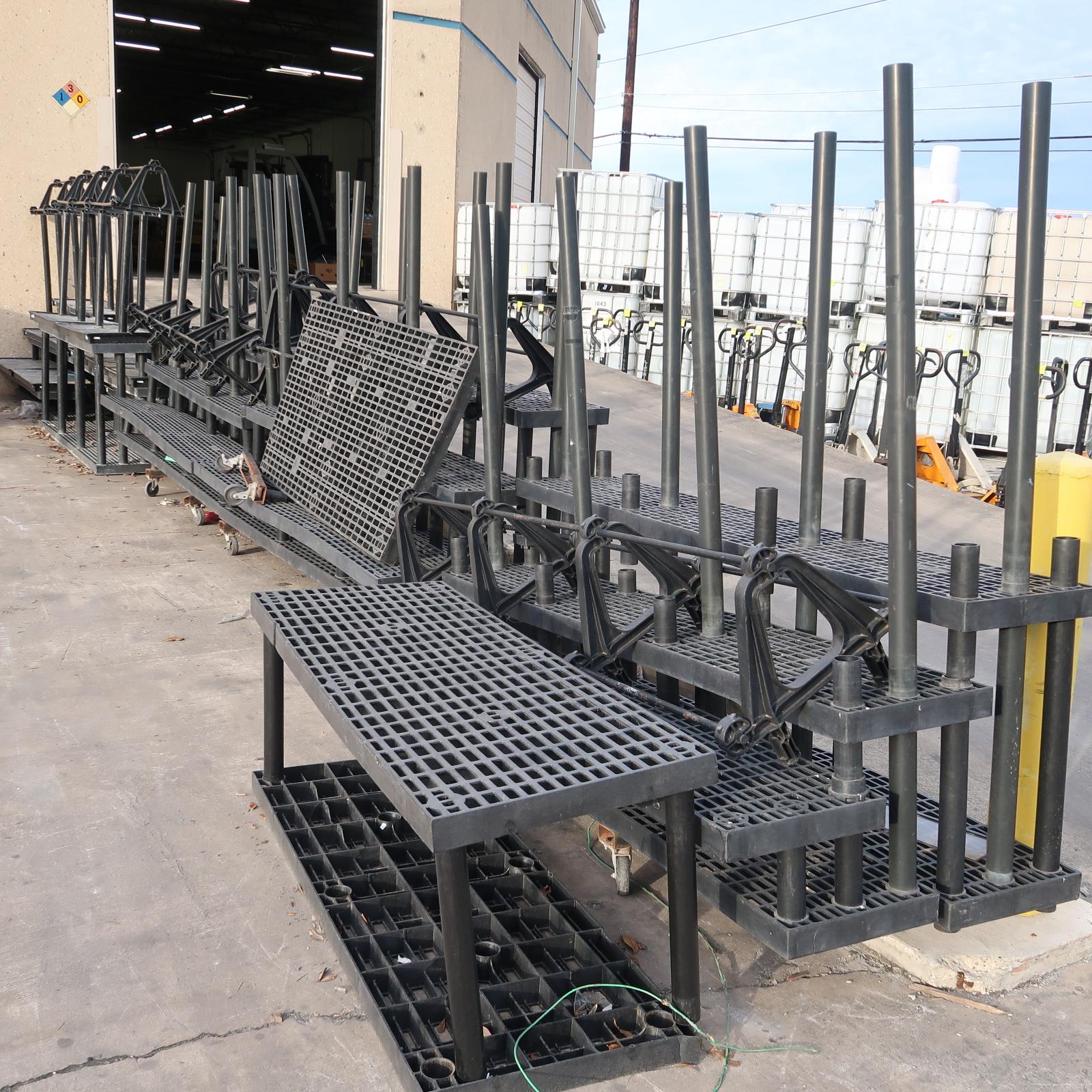 entire row of black plastic outdoor plant racks