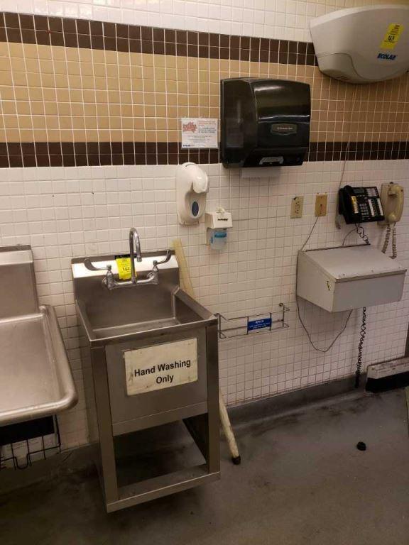 Stainless sink with paper towel and soap dispenser