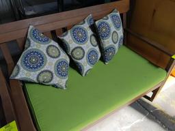 Wood bench with cushion and throw pillows