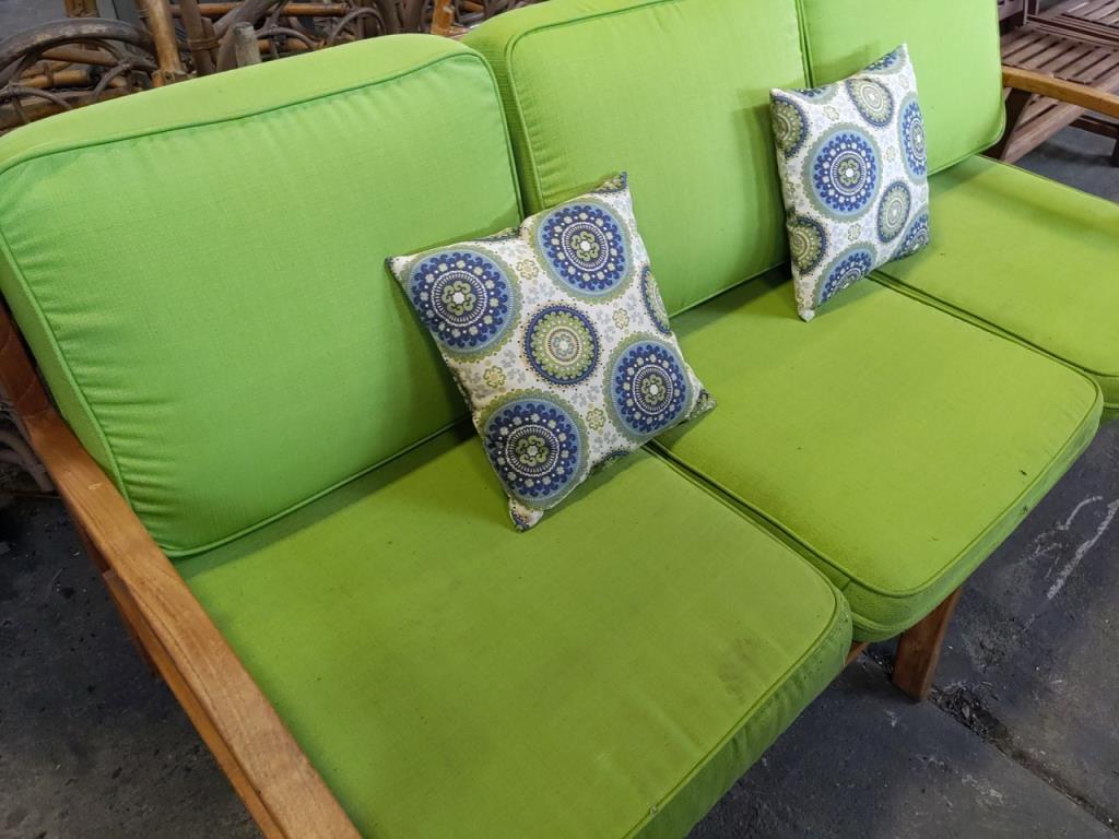 Wood bench with cushion and throw pillows