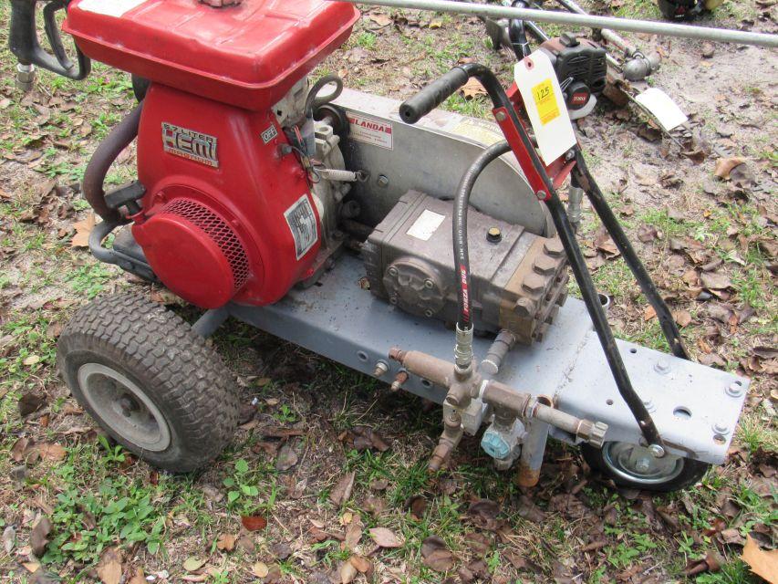 portable gasoline powered magnum pressure washer mounted on cart.  Hoses, and spray gun included