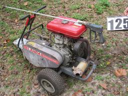 portable gasoline powered magnum pressure washer mounted on cart.  Hoses, and spray gun included