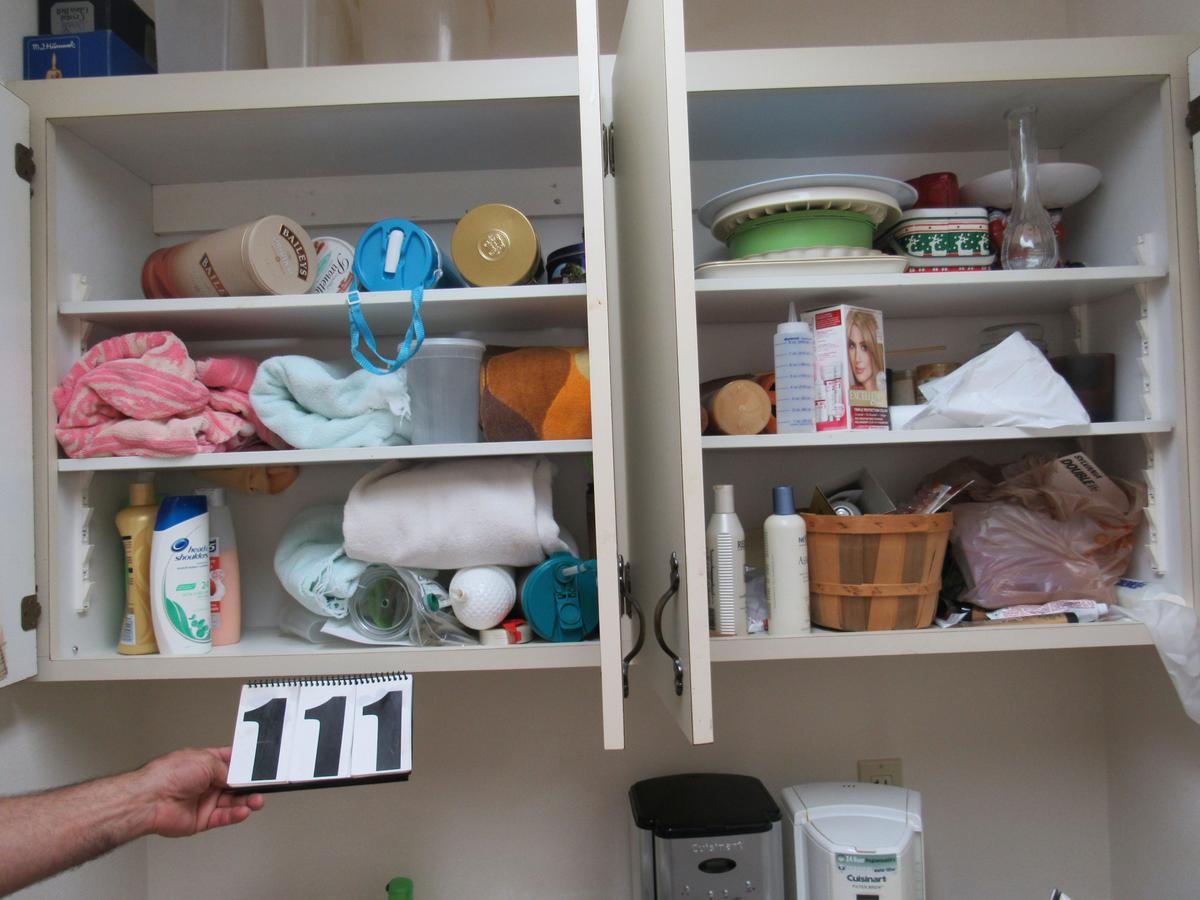 mixed houseware contents of utility cabinets above laundry sink