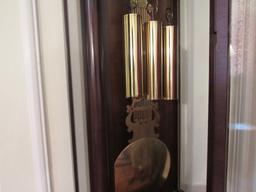 wall mounted grandfather clock made W Germany 21" w x 12" d x 68" h.  Works great chimes and keeps t