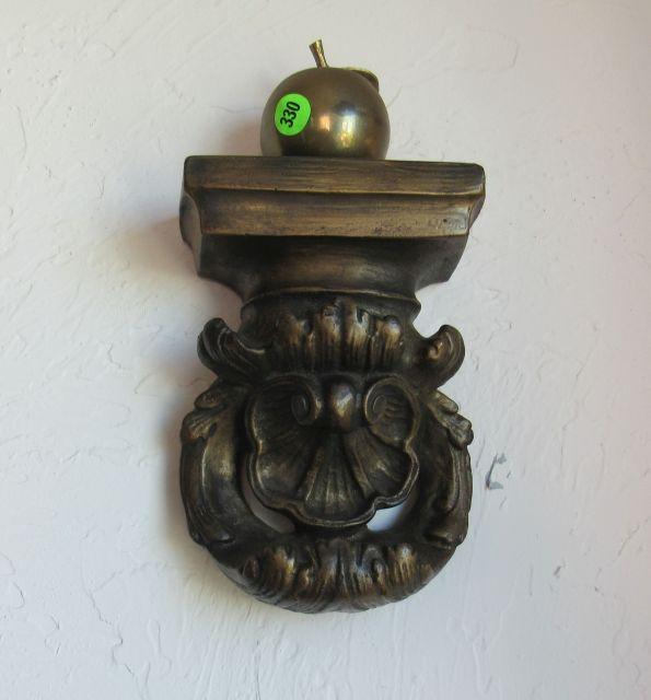 plaster wall figure with brass apple