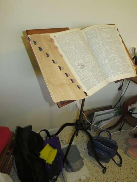 antique metal book stand with large dictionary