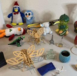 vases, bundle of eclipse glasses, candles, doodads, toys, statues, metal jack, scrimshaw pipe, gold
