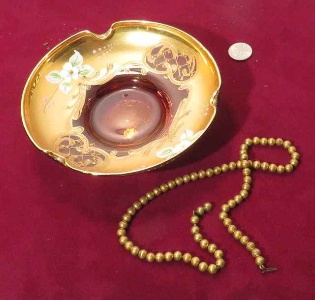 gold leaf ashtray with hand painted flowers plus small string of gold colored beads