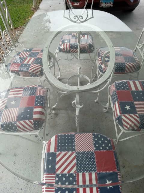 wrought iron patio set with glass table