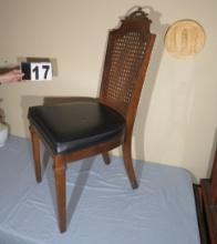 caned back chair with ornate metal handle with vinyl seat cushion