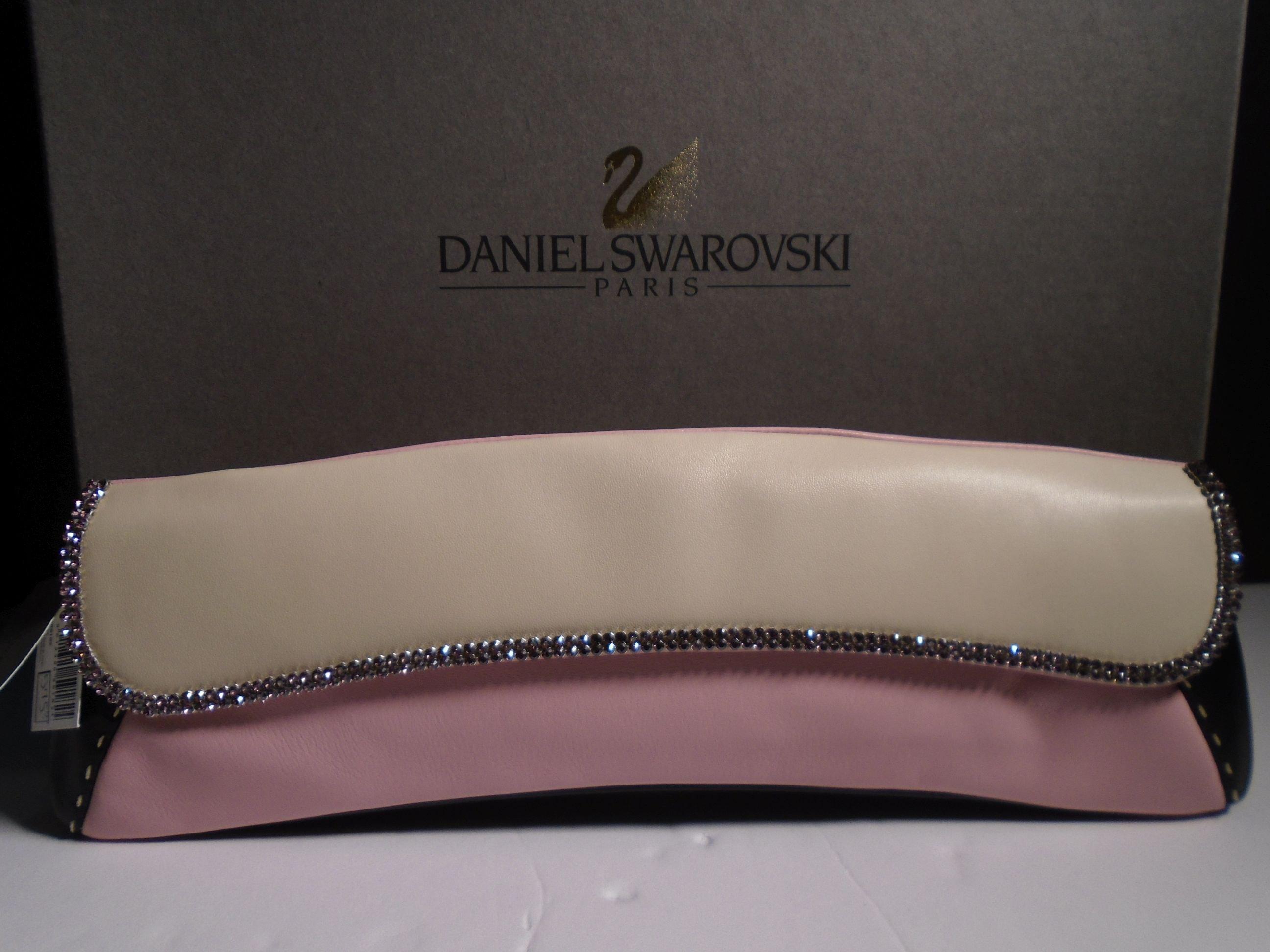 "Jaguar" Daniel Swarovski, champagne, pink & black lambskin clutch with pink strap.