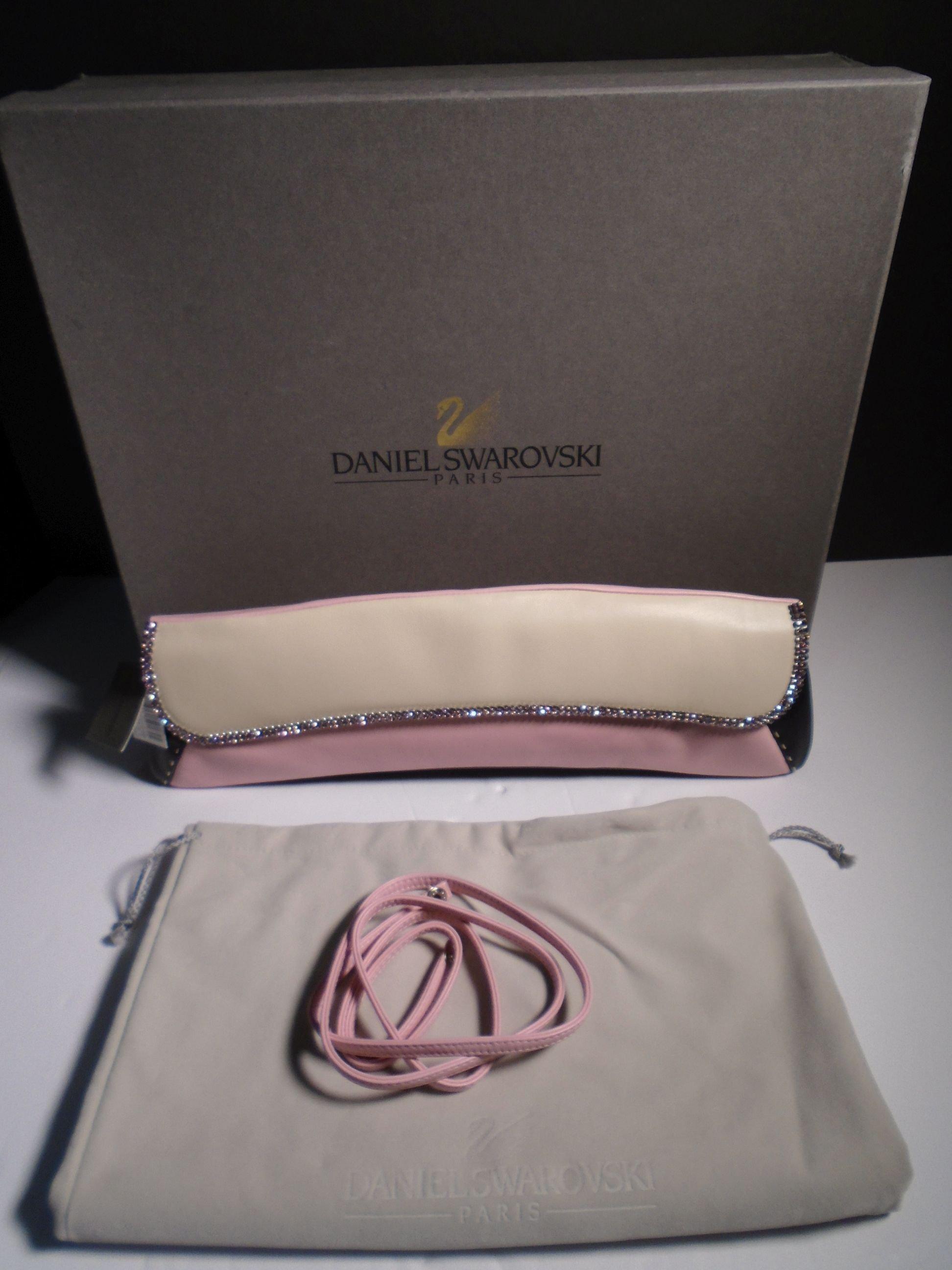 "Jaguar" Daniel Swarovski, champagne, pink & black lambskin clutch with pink strap.
