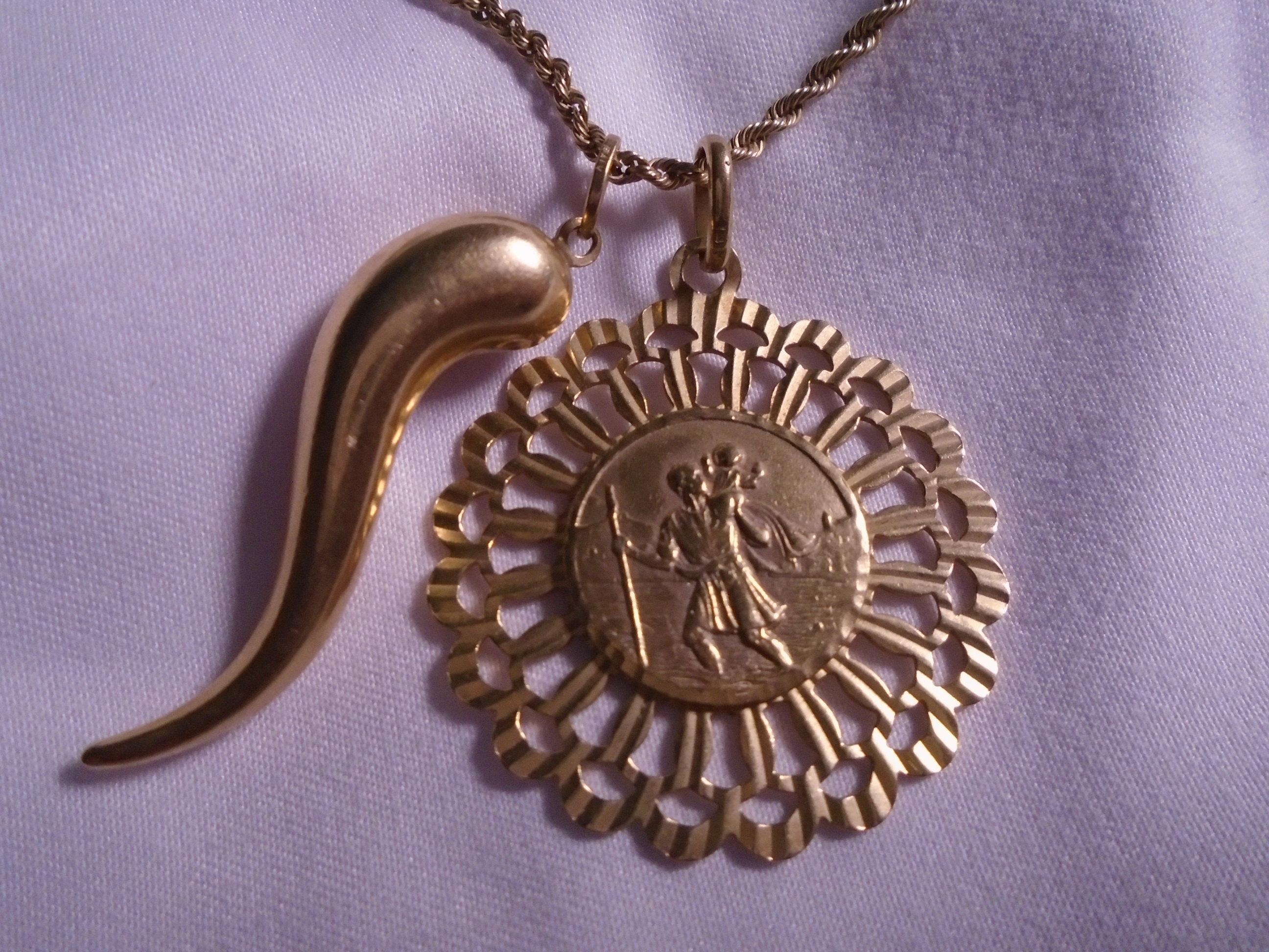 14kt yellow gold necklace with chili pepper pendant and coin pendant.