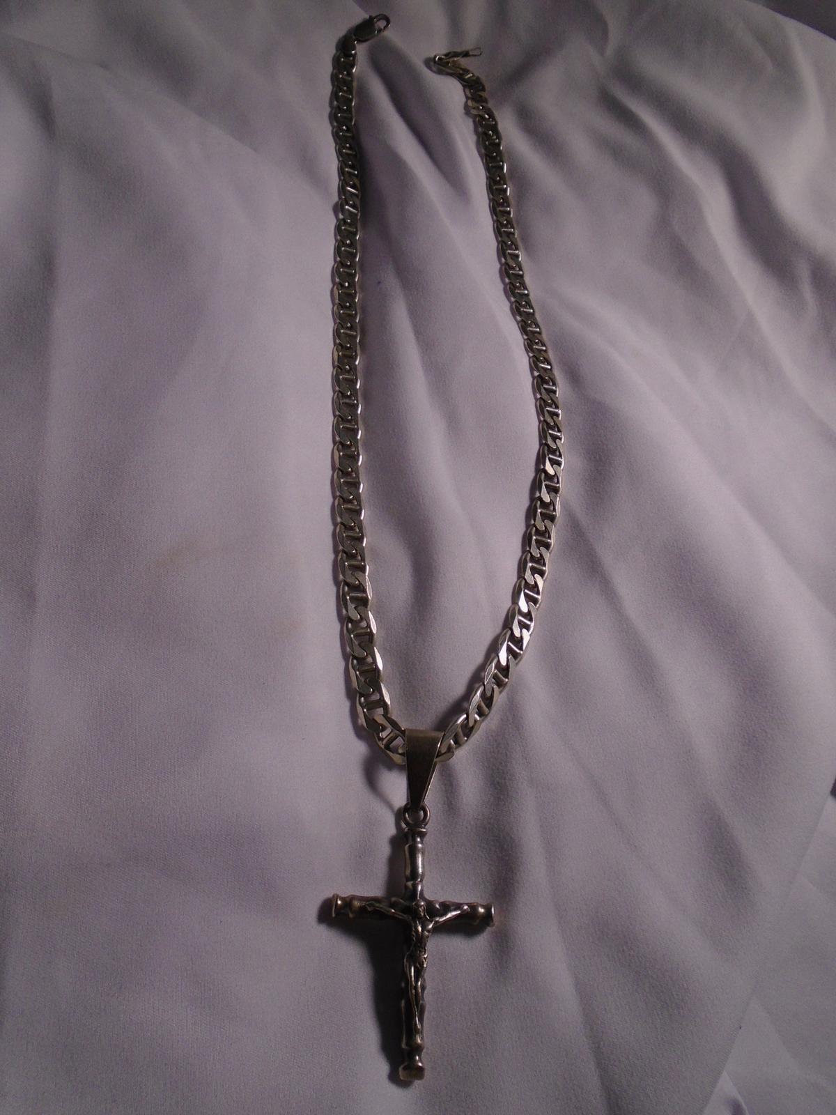 Men's Sterling silver necklace with a crucifix pendant.